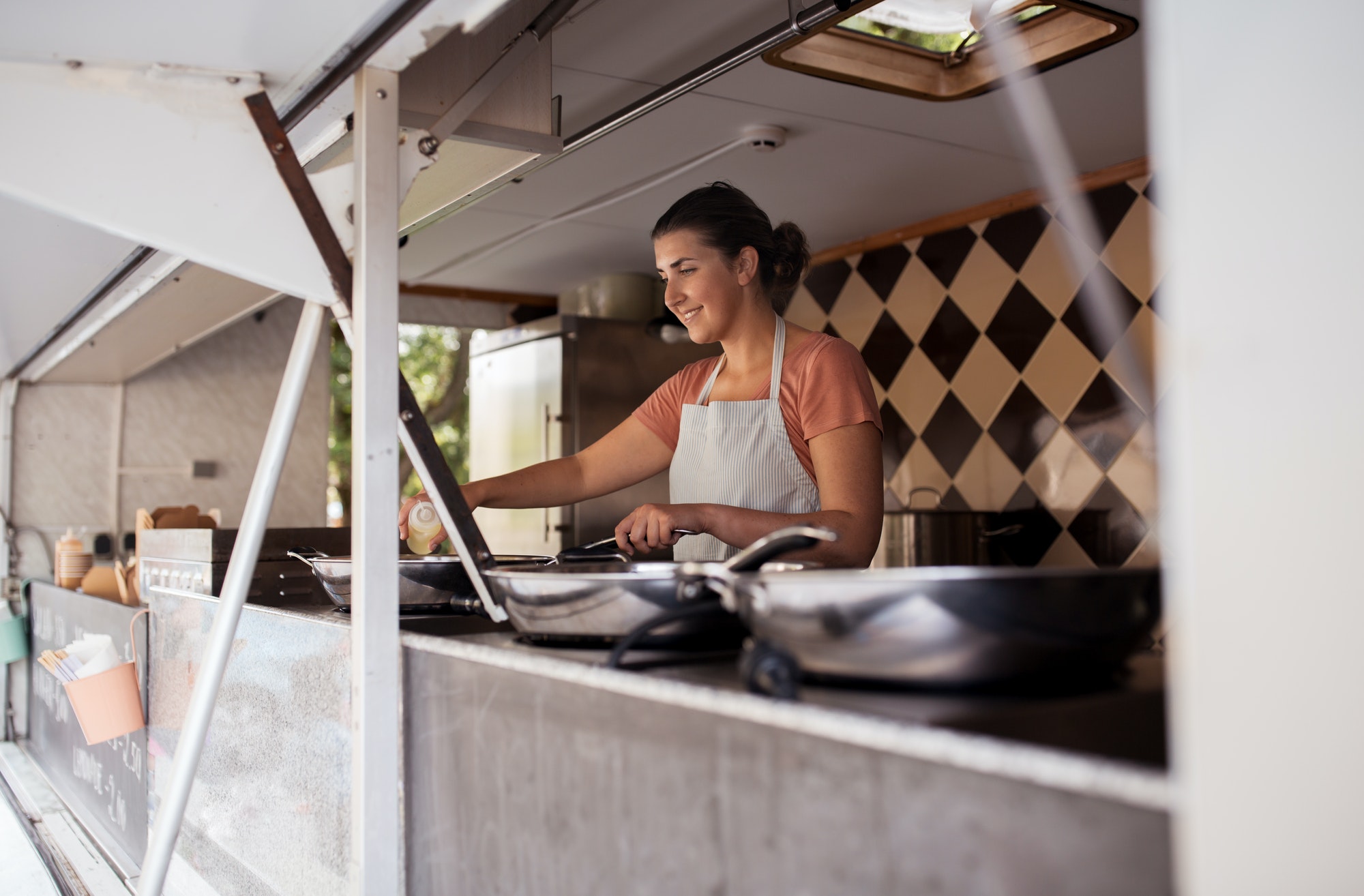 happy chef or seller cooking at food truck